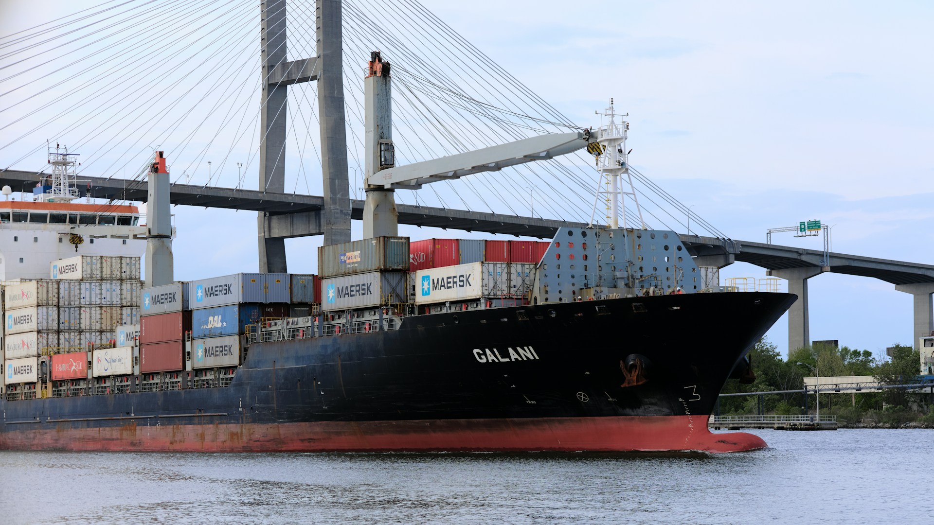 A cargo ship carrying a load of containers on their way through customs