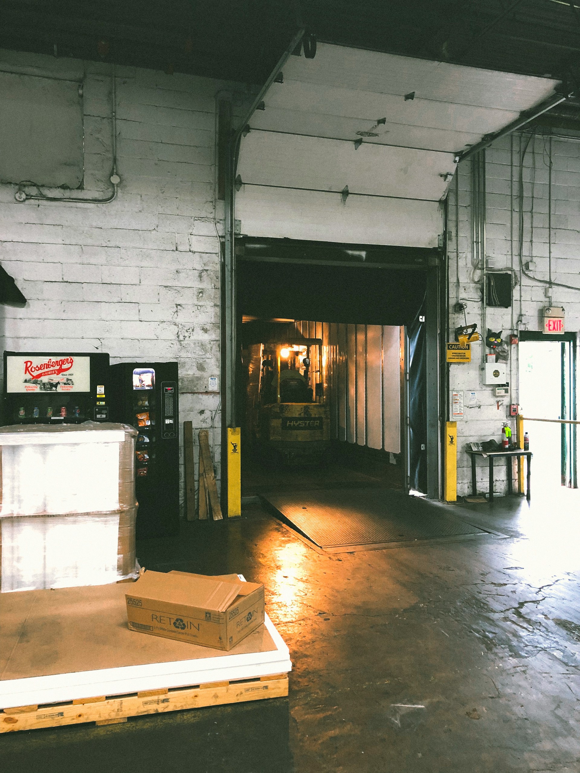 A refrigerated warehouse interior with shipping boxes and insulated packaging being staged for delivery. Clean, modern, high-tech atmosphere.